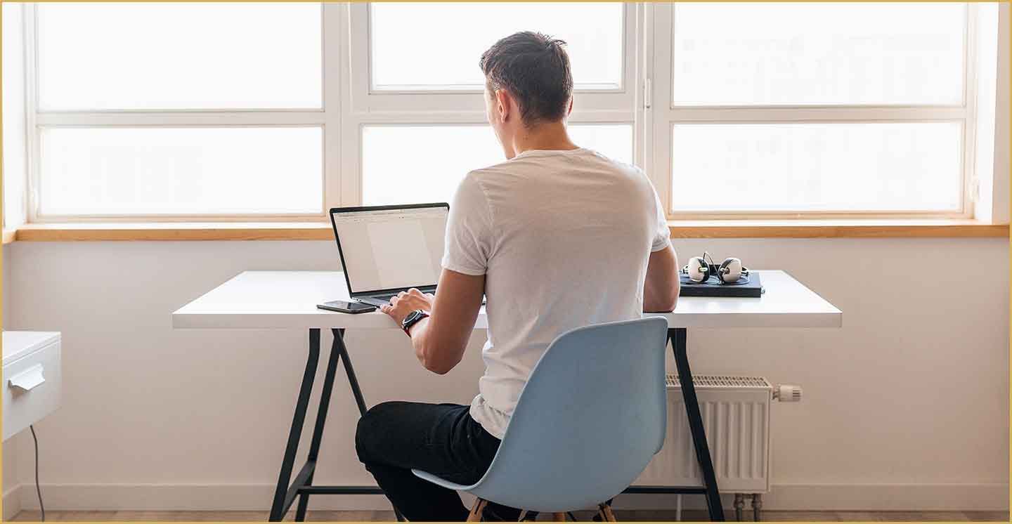 Man working on his laptop in his home office