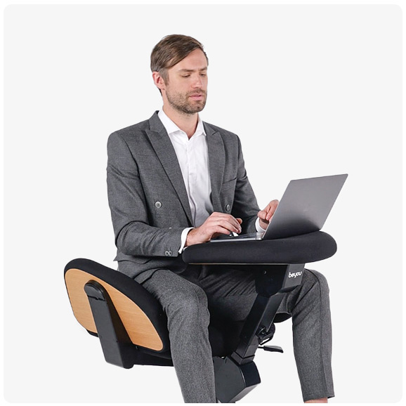 Business Man sitting on BeYou Chair working on a laptop